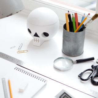 Acne Jr toy skull container on a designer's desk