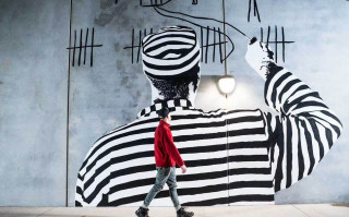 Mural by Sonsie Studios showing prisoner drawing tally marks