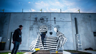 Sonsie Studios mural at Karreenga Prison depicting an inmate painting a landscape on a wall