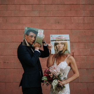 Wedding couple with record covers over faces, by Todd and Alyda McGaw
