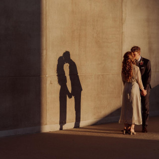 Couple's shadow kissing on sunlit wall, Todd and Alyda McGaw project