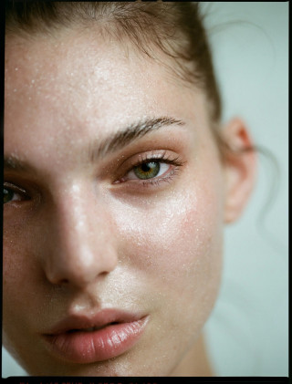 Close-up of a woman's face with dewy skin, part of Vivienne Balla's Jewellery + Beauty + Fashion series