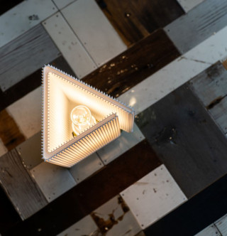 RIFT Lamp by Yongwon Kwon, triangular structure with glowing bulb on checkered surface