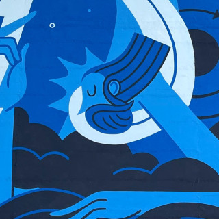 Abstract blue mural by Joren Joshua featuring stylized waves and a celestial figure